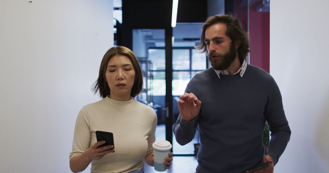 Business Colleagues Walking in Modern Office with Gadgets
