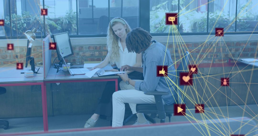 Colleagues collaborating over documents with digital network overlay in modern office