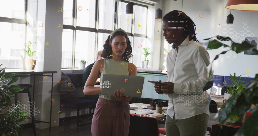 Coworkers Collaborating with Digital Data in Modern Office