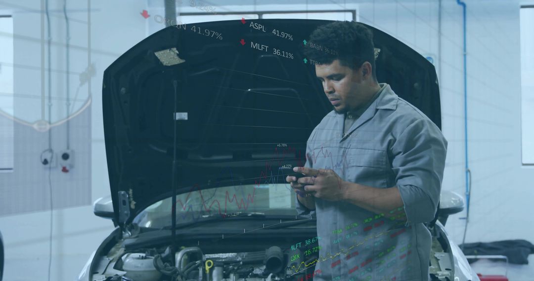 Mechanic Using Smartphone for Automotive Diagnostics in Workshop