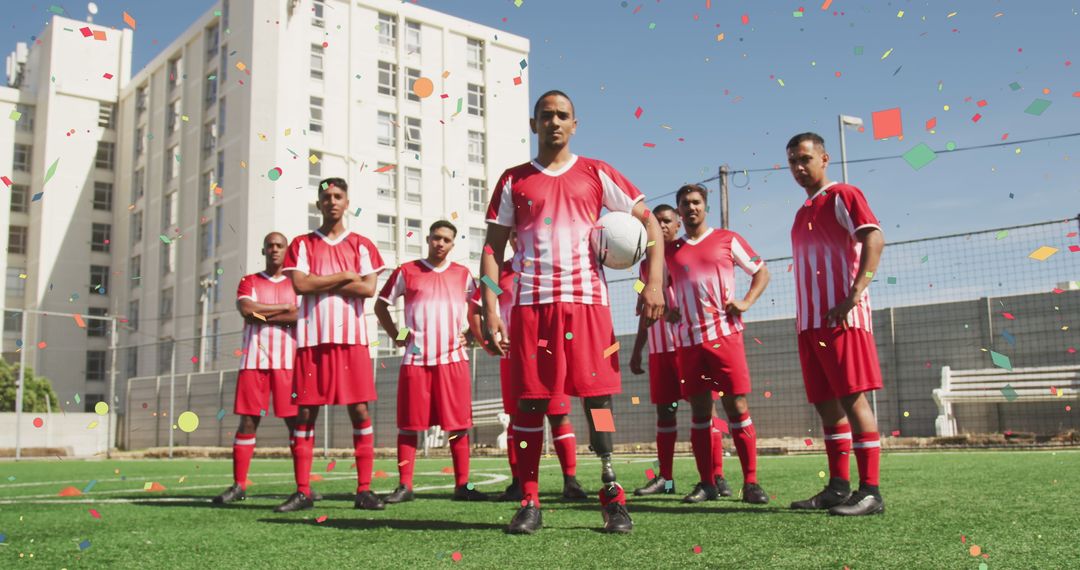 Male football team celebrating victory with falling confetti