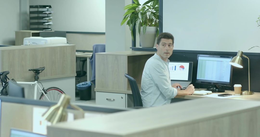 Professional Analyzing Charts in Office with Bicycle and Modern Workspace