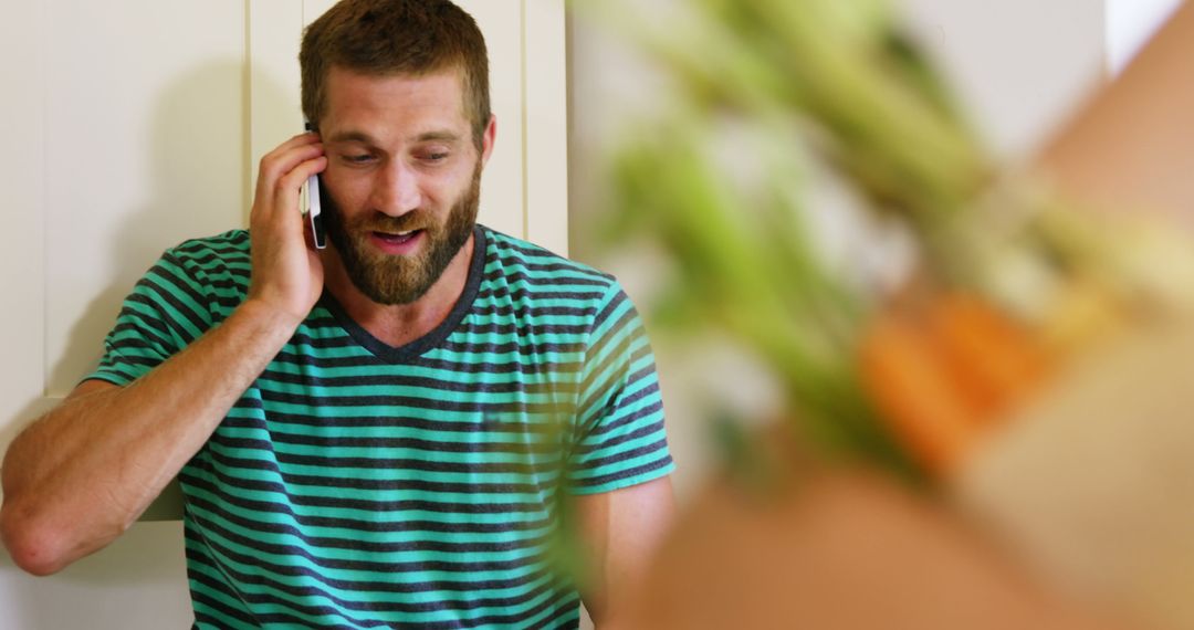 Relaxed Man Talking on Phone in Casual Home Atmosphere - Free Images, Stock Photos and Pictures on Pikwizard.com