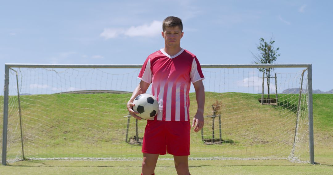 Young Soccer Player Standing in Front of Goal with Ball - Free Images, Stock Photos and Pictures on Pikwizard.com