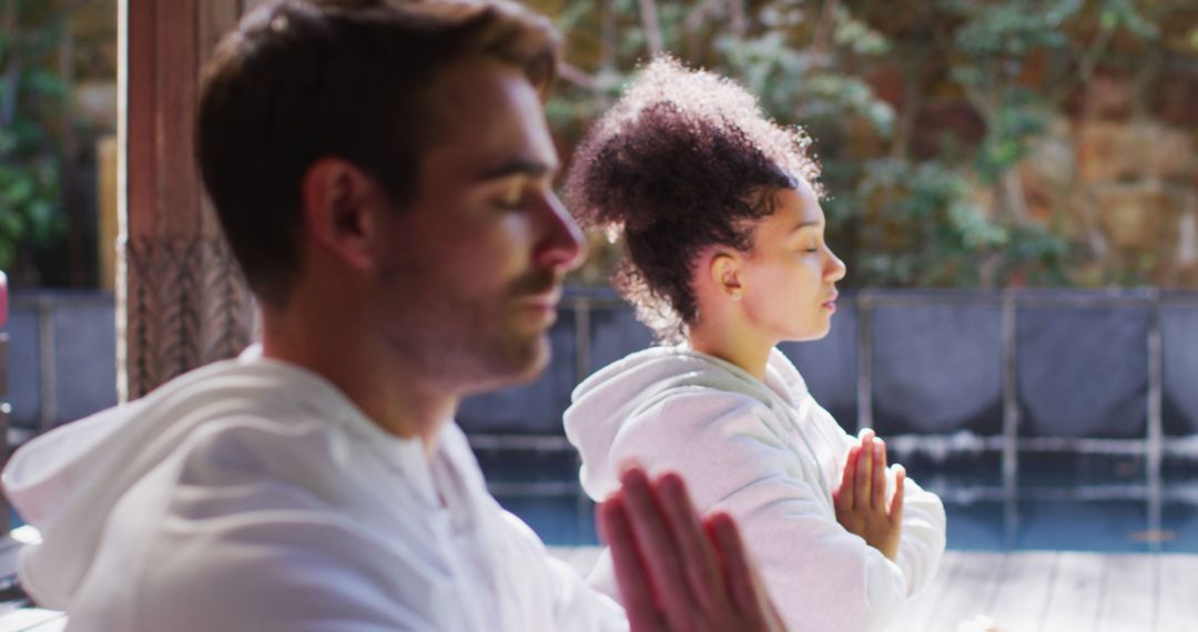 Biracial Couple Meditating Together in Serene Setting