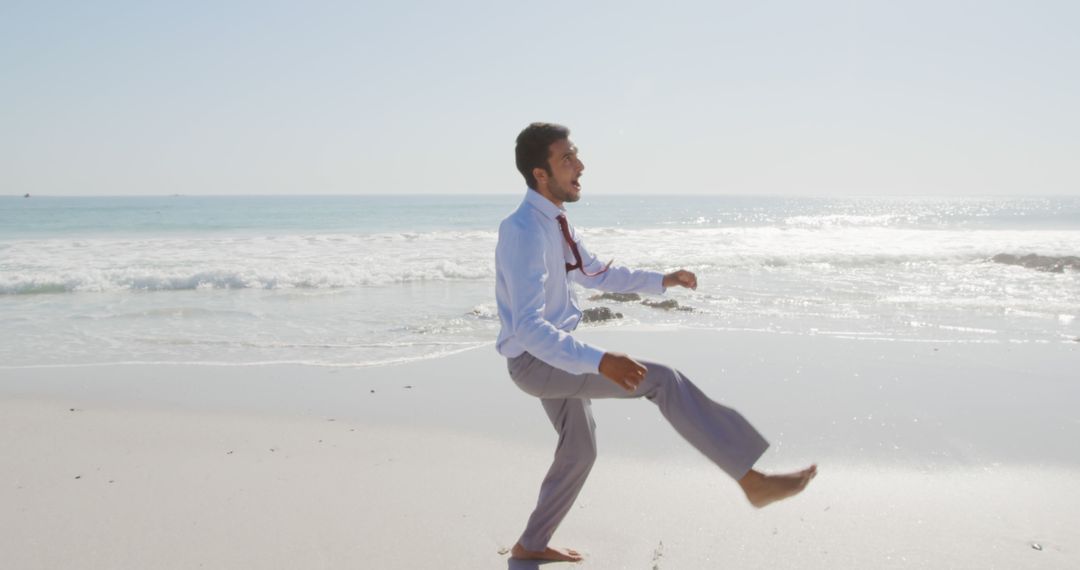 Businessman Walking on Beach Enjoying Relaxed Work Day - Free Images, Stock Photos and Pictures on Pikwizard.com