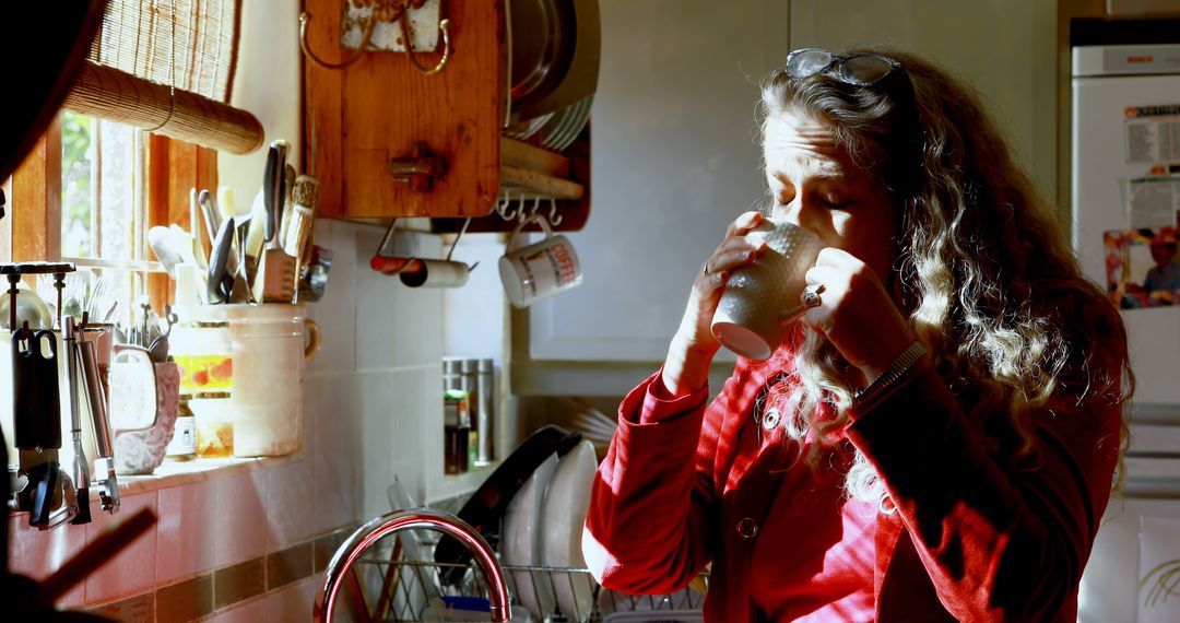 Woman Drinking Coffee in Morning Light in Cozy Kitchen - Free Images, Stock Photos and Pictures on Pikwizard.com