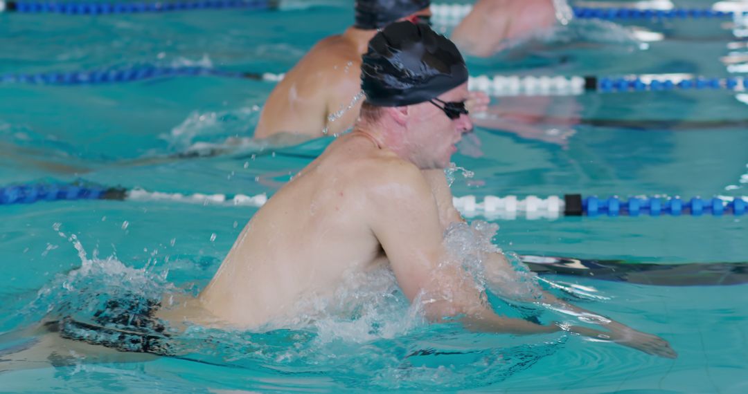 Competitive Swimmer in Pool During Breaststroke Race - Free Images, Stock Photos and Pictures on Pikwizard.com