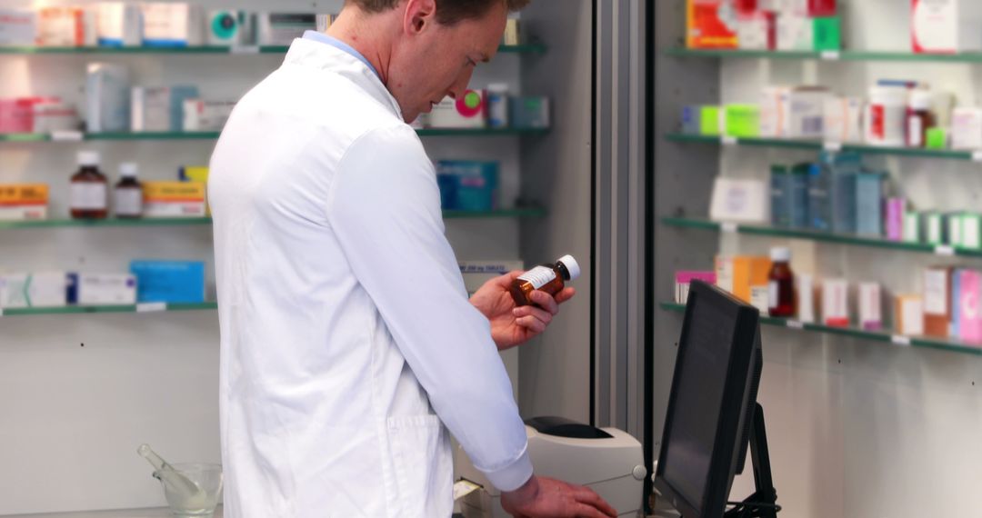 Male Pharmacist Checking Prescription Bottle in Pharmacy - Free Images, Stock Photos and Pictures on Pikwizard.com