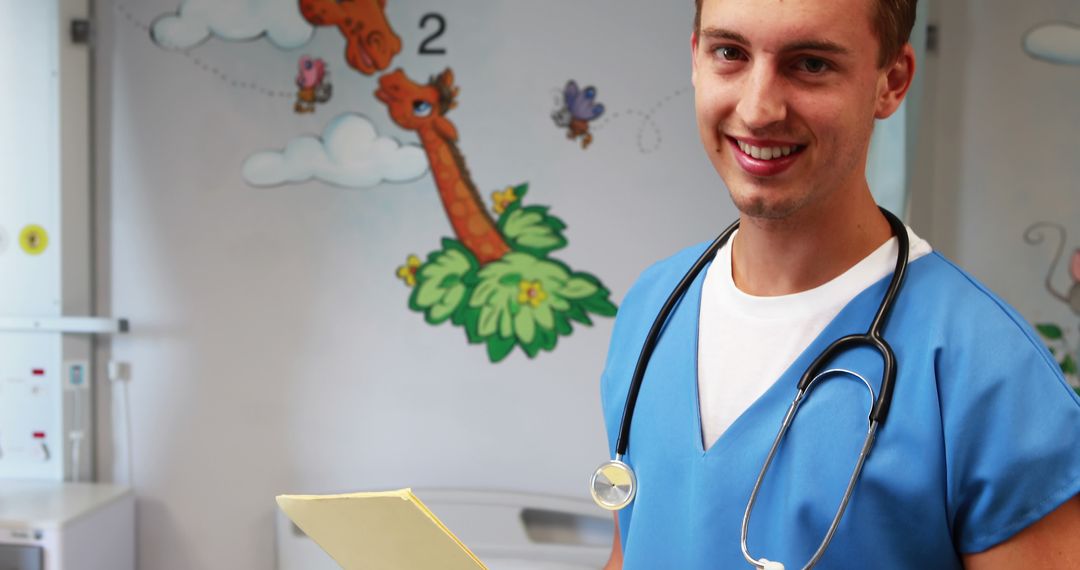 Smiling Male Nurse Holding Medical File in Pediatric Ward - Free Images, Stock Photos and Pictures on Pikwizard.com