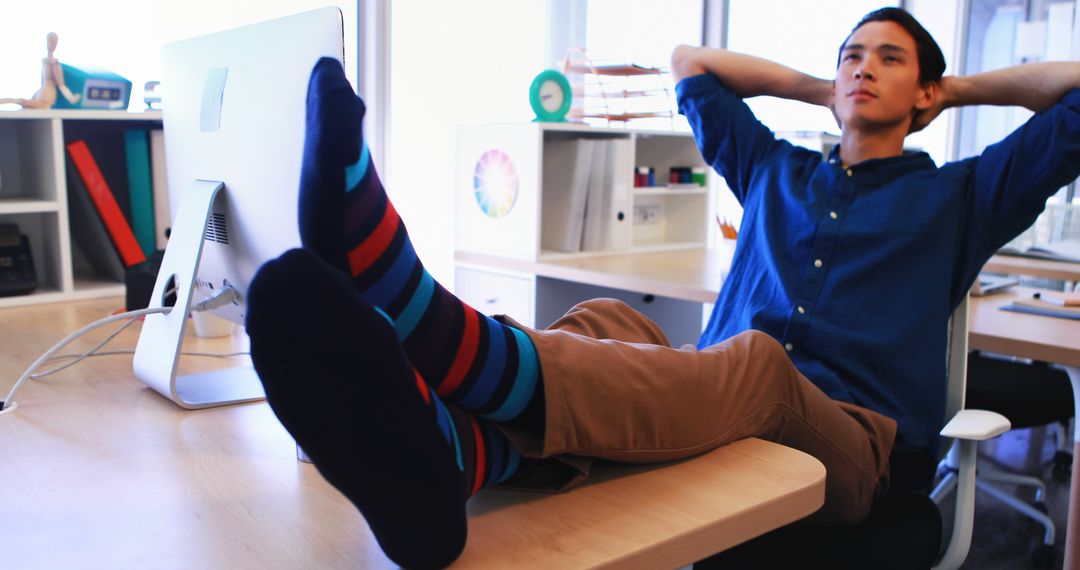 Man Relaxing at Office Desk with Feet Up in Striped Socks - Free Images, Stock Photos and Pictures on Pikwizard.com