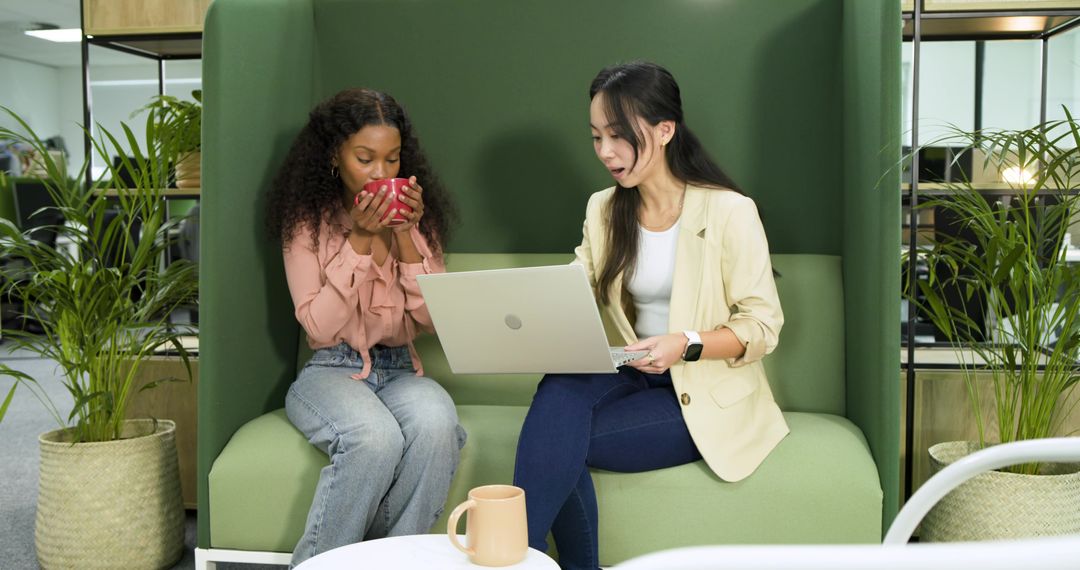 Diverse Coworkers Collaborating in Office Lounge Environment