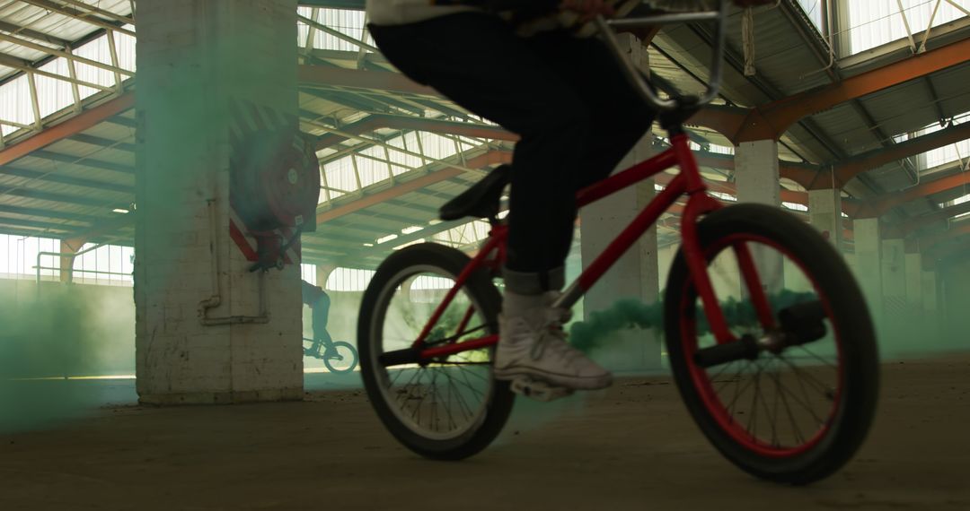 BMX Riders Performing Tricks in Abandoned Warehouse with Smoke - Free Images, Stock Photos and Pictures on Pikwizard.com