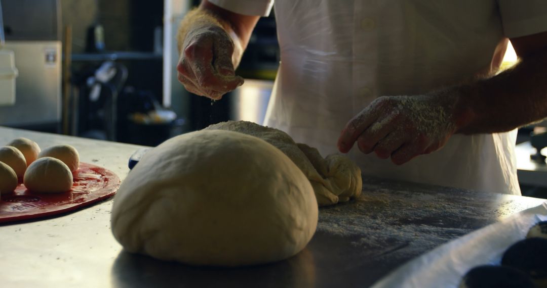 Baker kneading dough in commercial kitchen - Free Images, Stock Photos and Pictures on Pikwizard.com