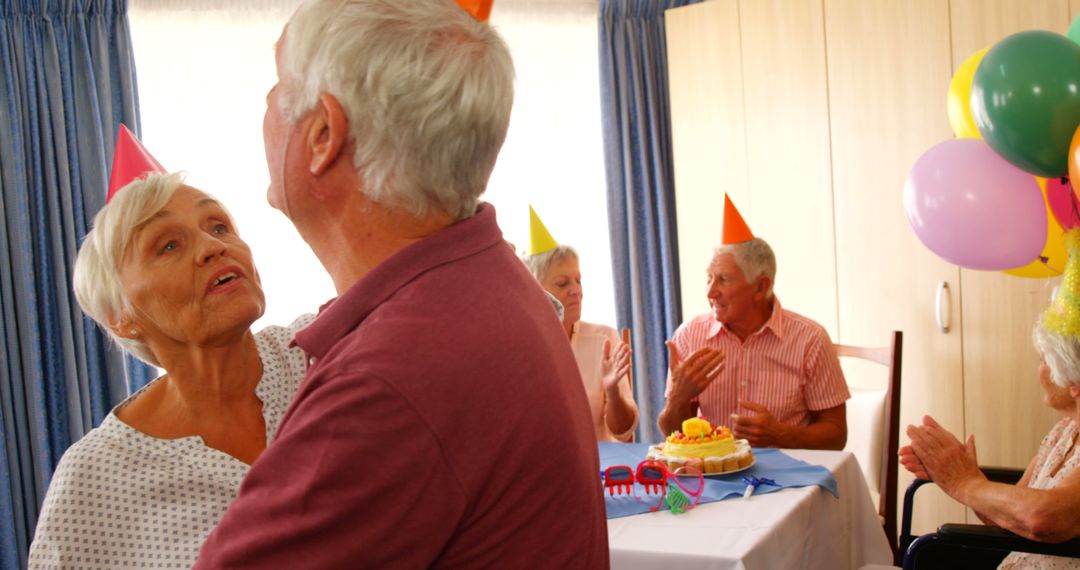 Elderly Couples Celebrating Birthday with Party Hats and Cake - Free Images, Stock Photos and Pictures on Pikwizard.com