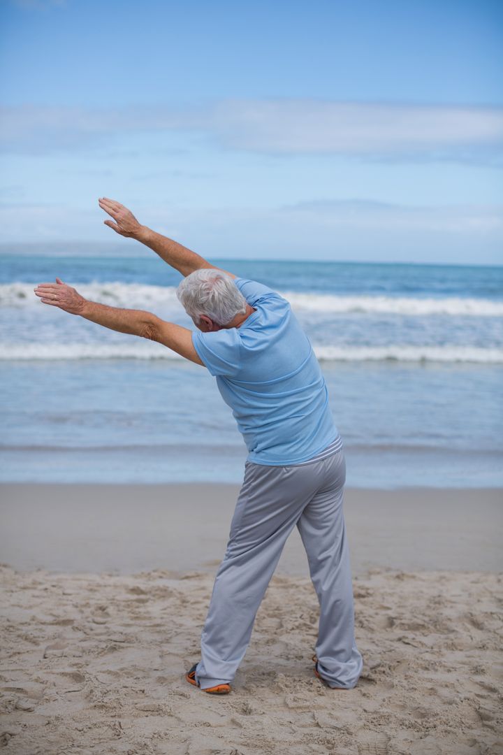 Senior Man Stretching on Beach - Free Images, Stock Photos and Pictures on Pikwizard.com