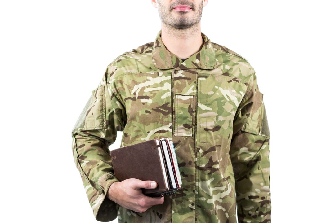Soldier Holding Books in Camouflage Uniform - Free Images, Stock Photos and Pictures on Pikwizard.com
