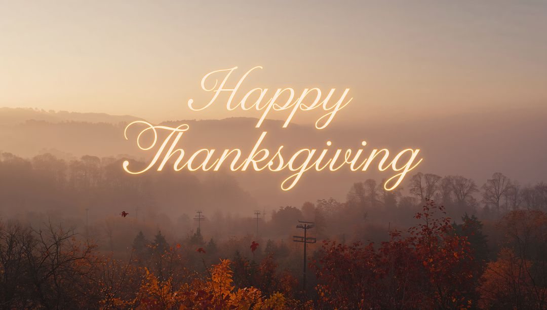Glowing Cursive Happy Thanksgiving over Misty Autumn Valley during Golden Hour Sunrise