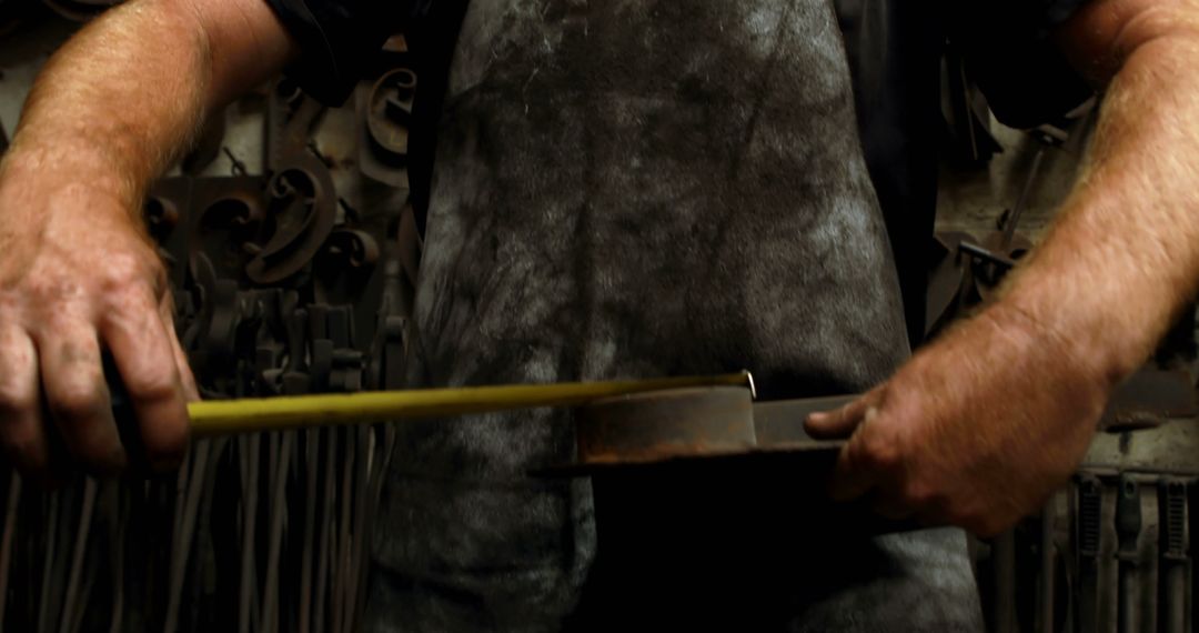 Close-Up of Blacksmith Measuring Metal with Yellow Tape Measure - Free Images, Stock Photos and Pictures on Pikwizard.com