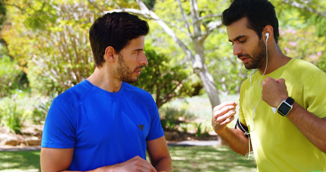 Two male athletes talking in park before outdoor workout - Free Images, Stock Photos and Pictures on Pikwizard.com