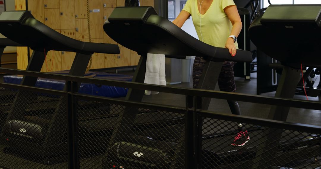 Senior Woman Trainer on Treadmill, Exercising in Gym