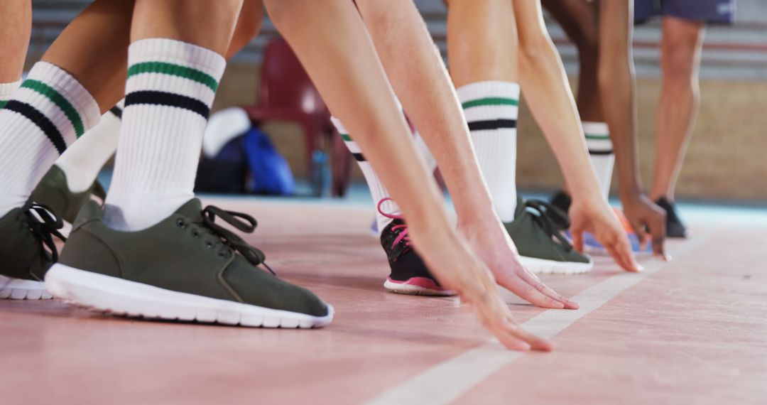 Athletes Ready to Race on Indoor Track Showing Determination