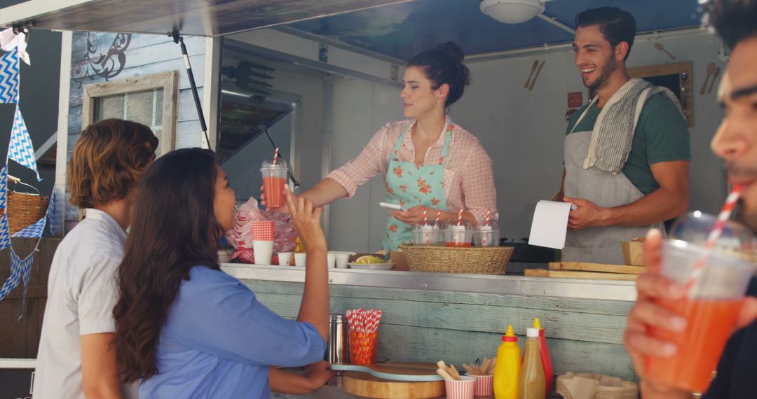 Friendly Food Truck Vendors Serving Refreshing Drinks to Customers - Free Images, Stock Photos and Pictures on Pikwizard.com