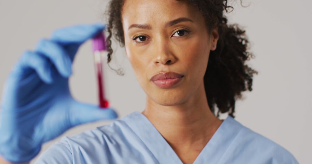 Confident African American Nurse Holding Blood Sample in Medical Lab - Free Images, Stock Photos and Pictures on Pikwizard.com