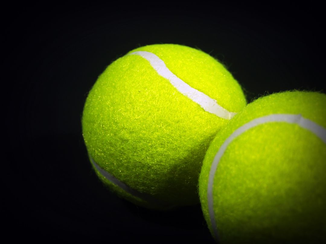 Close-Up of Tennis Balls with Yellow Felt Against Black Background - Free Images, Stock Photos and Pictures on Pikwizard.com