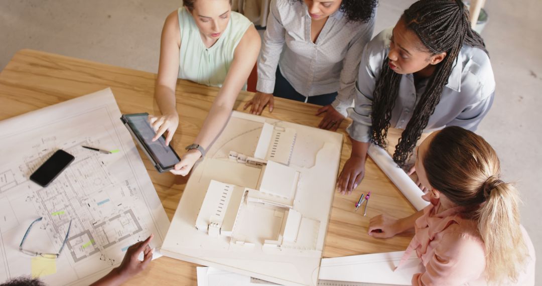 Diverse Group of Female Architects Collaborating on Construction Designs at Work - Free Images, Stock Photos and Pictures on Pikwizard.com