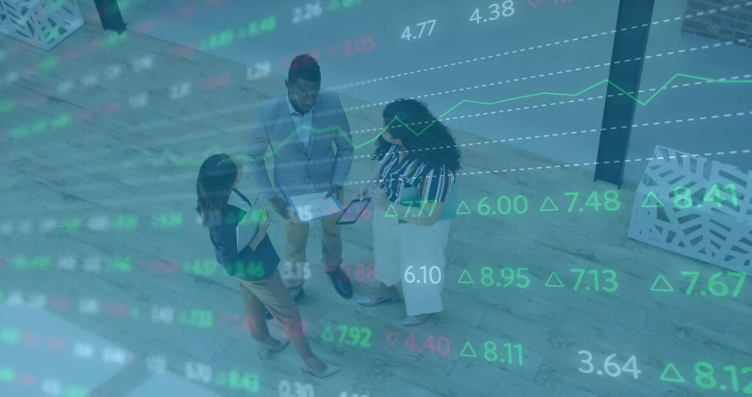 Top-down team collaborating over tablet with financial market data overlay