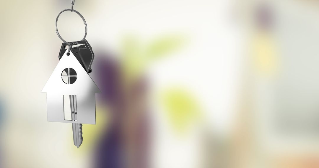 House Shaped Keychain Indoors Symbolizing Home Ownership