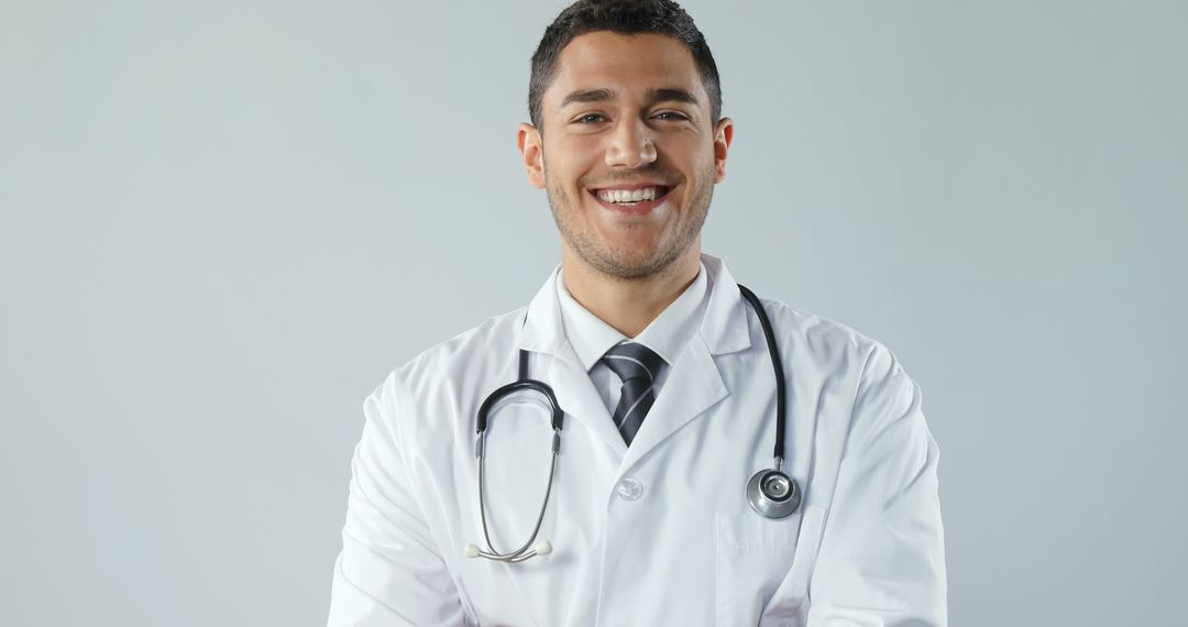 Confident Young Male Doctor Smiling with Stethoscope in Hospital - Free Images, Stock Photos and Pictures on Pikwizard.com