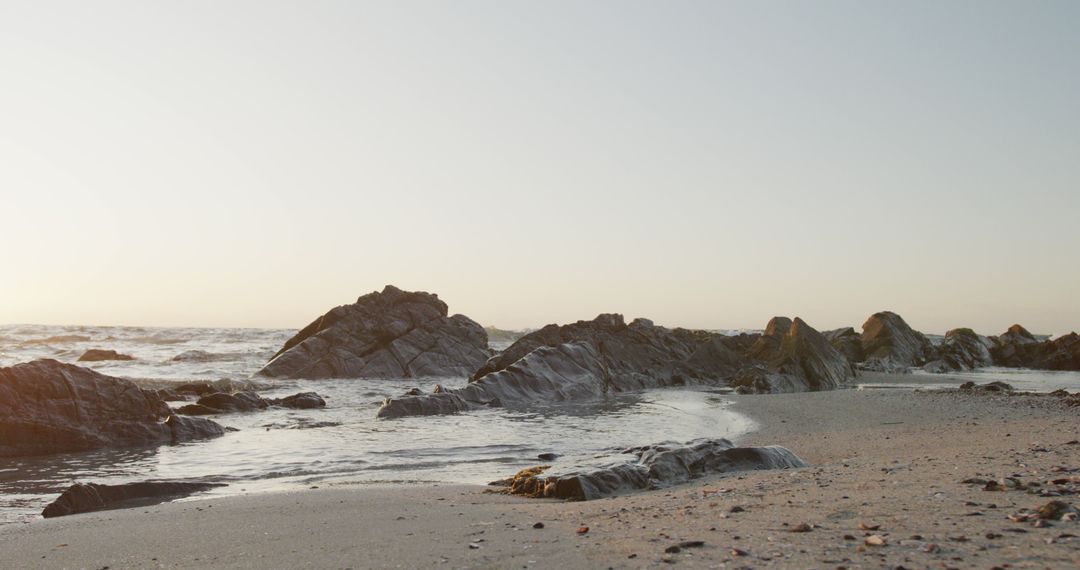 Calm Sunset Over Rocky Coastal Beach - Free Images, Stock Photos and Pictures on Pikwizard.com