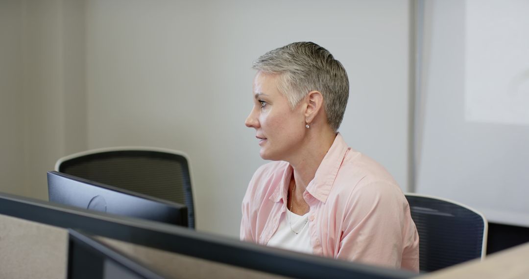 Senior Professional Working at Computer Station with Modern Decor