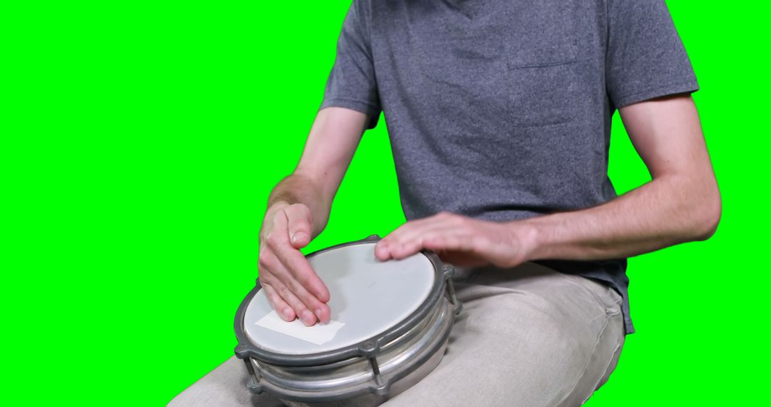 Mid section of drummer playing drum against green screen - Free Images, Stock Photos and Pictures on Pikwizard.com