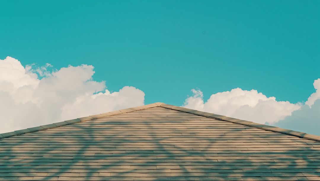 Triangular Roof with Asphalt Shingles Under Clear Blue Sky