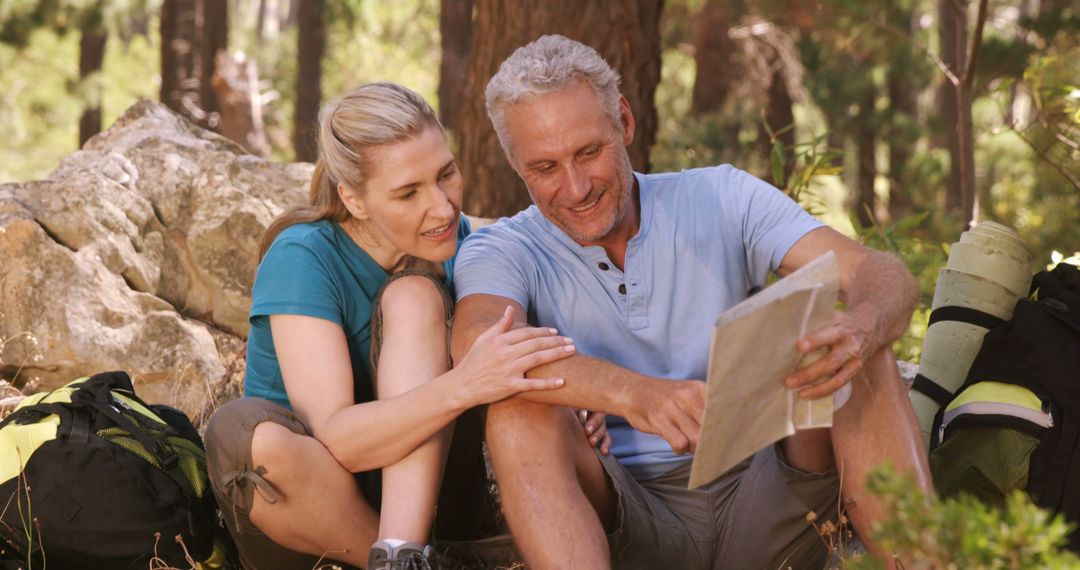 Senior Couple Navigating with Map in Forest Outdoors