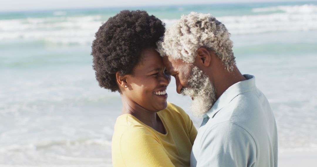 Joyful Senior Couple Embracing at Beachside on Sunny Day