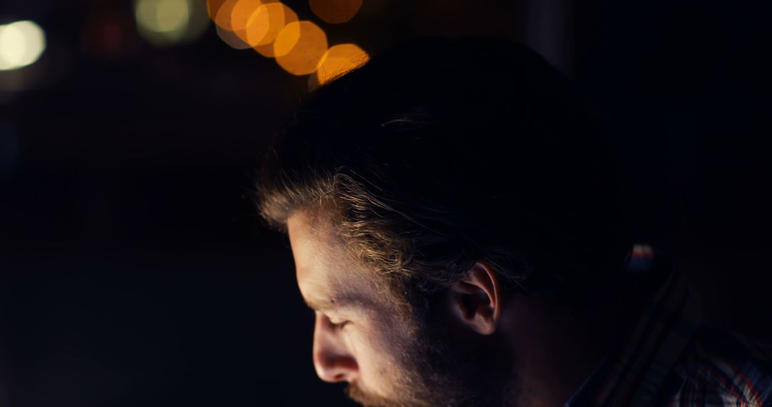 Man with Beard Working on Computer at Night with Bokeh Lights - Free Images, Stock Photos and Pictures on Pikwizard.com