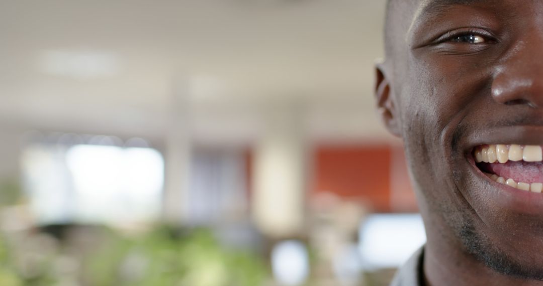 Close-Up of African American Man Smiling in Office Environment - Free Images, Stock Photos and Pictures on Pikwizard.com