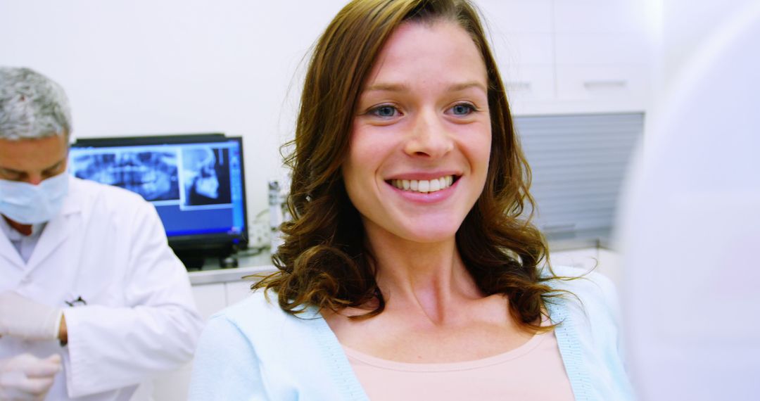 Smiling Woman Receiving Dental Treatment in Clinic - Free Images, Stock Photos and Pictures on Pikwizard.com