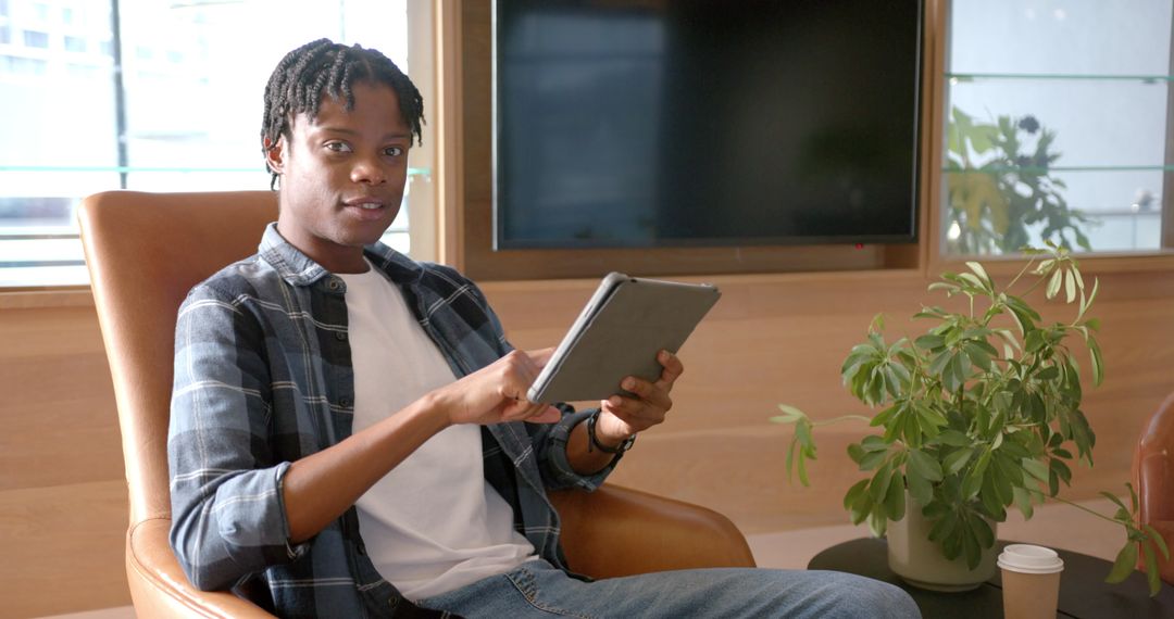 Man Using Tablet in Modern Office for Work