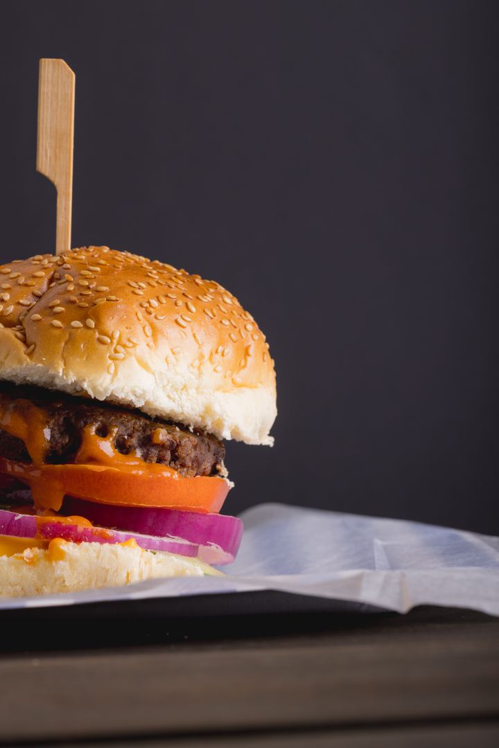 Close-up of burger on table against gray background with copy space - Free Images, Stock Photos and Pictures on Pikwizard.com