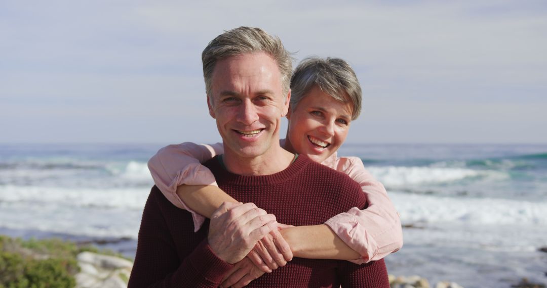 Smiling Happy Senior Couple Embracing at Beach - Free Images, Stock Photos and Pictures on Pikwizard.com