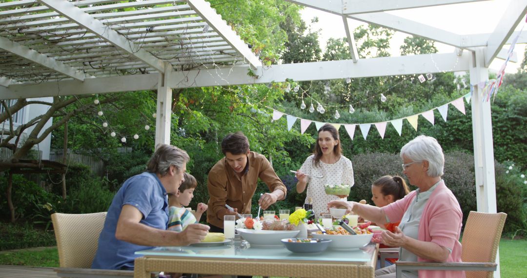 Family Enjoying Outdoor Meal Under Pergola - Free Images, Stock Photos and Pictures on Pikwizard.com