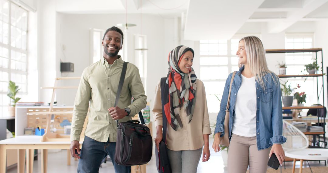 Diverse Team of Colleagues Walking and Smiling in Modern Office Space