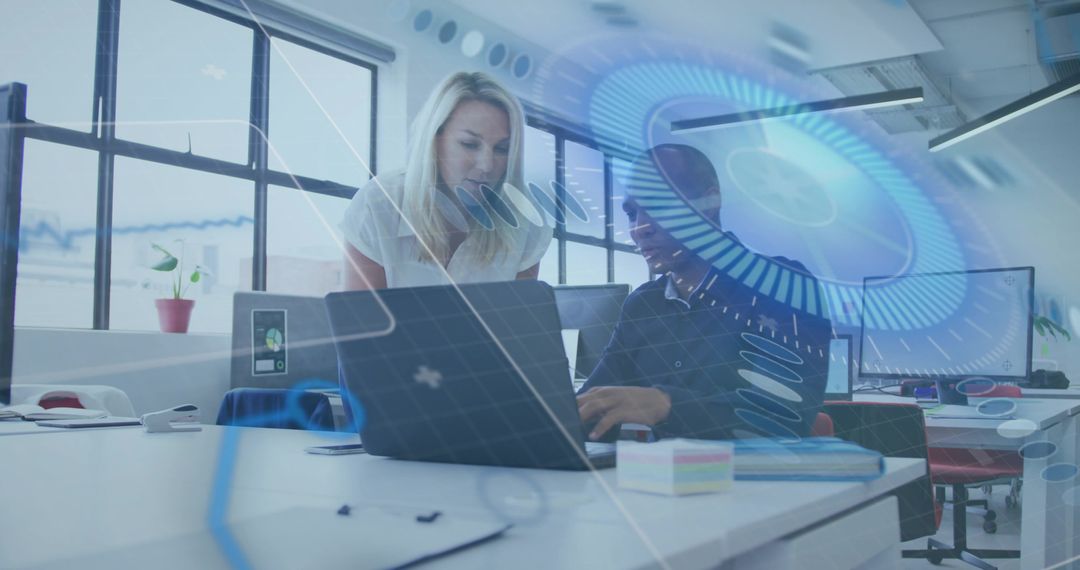 Collaborating on laptop with holographic interface in modern open office mentoring scene