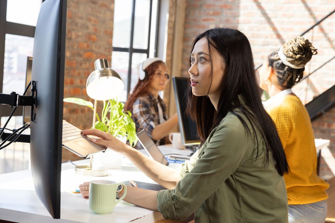 Diverse Female Coworkers Collaborating in Modern Open Office