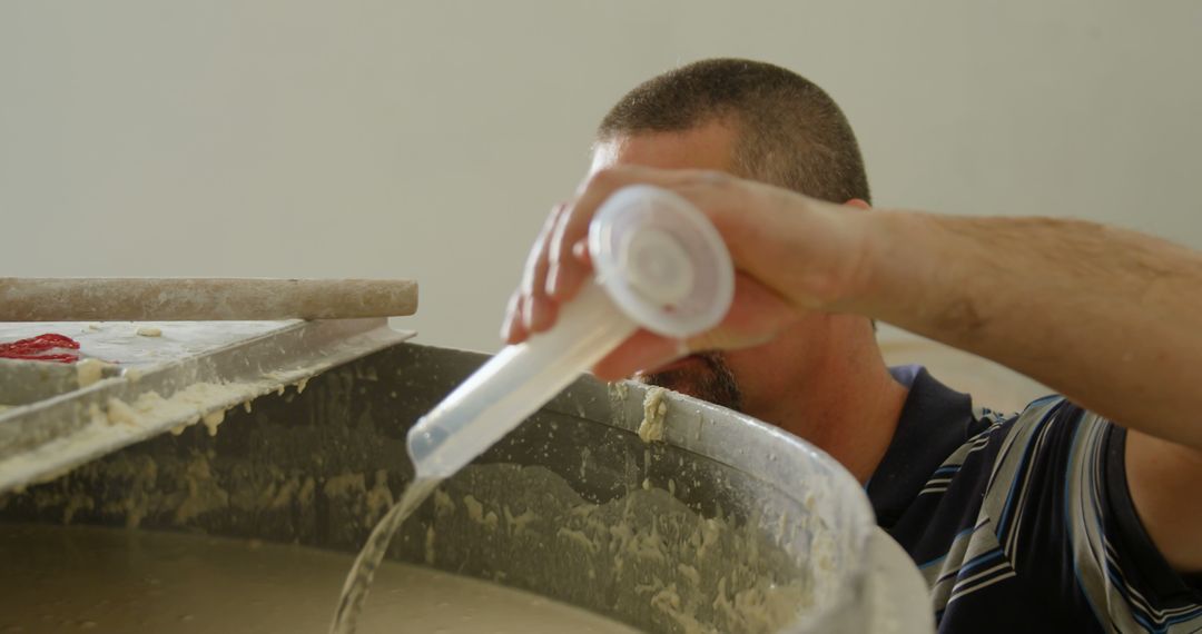 Caucasian Worker Mixing Construction Materials on Site - Free Images, Stock Photos and Pictures on Pikwizard.com